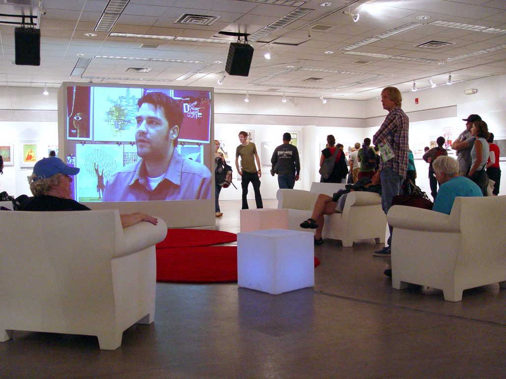 Visitors watching one of the exhibit films.