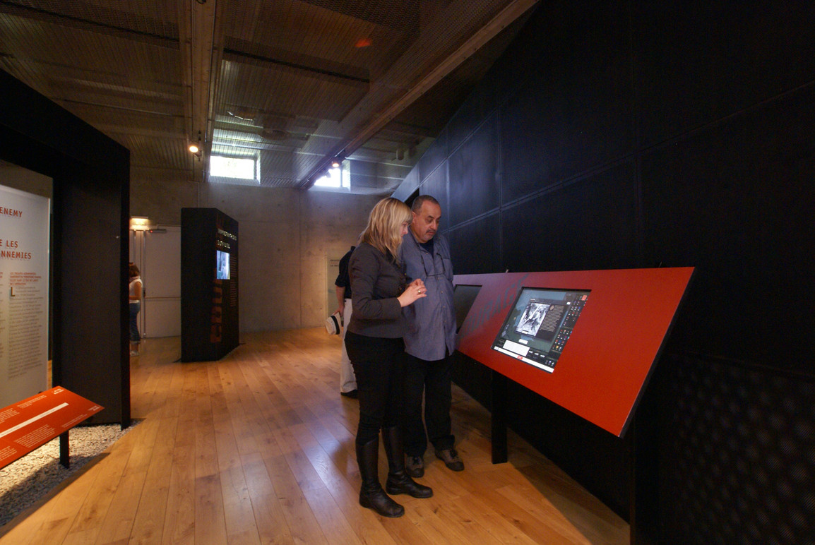 Visitors in the gallery using the kiosk.
